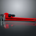 Red Pipe Wrench Tool Placed On Black Reflective Surface Background