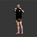 Man In Black T Shirt And Yellow Shorts With White Boxing Gloves Training Stance