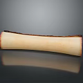Curved Bone Shaped Object With Light Beige Surface And Dark Roasted Edges