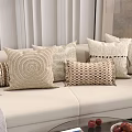 Neutral Toned Throw Pillows With Various Textures On Beige Sofa Living Room