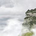 Natural Garden Landscape Featuring Cliff Surrounded By Clouds Mist And Lush Green Vegetation