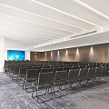 Spacious Conference Room Interior With Black Folding Chairs Large Screen And Wooden Walls