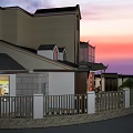 Modern Detached Villa With Large Glass Windows Dark Tile Roof Landscaped Garden And Sunset Sky