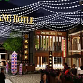 Vibrant Commercial Street with Kin Kang Hotel Signboards Lanterns and String Lights