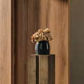 Black Ceramic Vase With Brown Hydrangea Flowers On Wooden Pedestal Against Wooden Wall