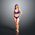 Woman Standing in Blue Bikini Against Gray Studio Background