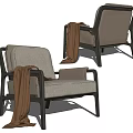 Comfortable Modern Leisure Chair With Gray Fabric Black Metal Frame And Brown Throw Blanket