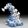 Art Installation with White Container Pouring Blue and White Spherical Elements Forming Stacked Sculptural