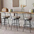 Stylish Bar Counter With Wooden Top Stone Base Three Bar Stools Decorations And Green Plant