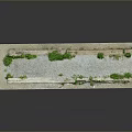 Scenic Landscape Of Rectangular Stone Slab With Green Plants And Gray Gravel Extending Over Edges