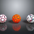 Colorful Soccer Balls With Red White Orange And Blue Patterns On Reflective Background