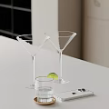 Clear Martini Glasses With Lime Wedge Small Glass And Mobile Phone On White Tabletop