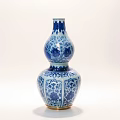Blue and White Gourd Shaped Ceramic Vase With Intricate Patterns And Golden Base