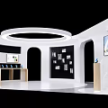 White Exhibition Booth With Circular Ceiling Light Black Backdrop Display Shelves Screens And Wooden Counters