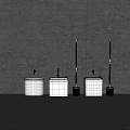 White Toilet Tanks And Brushes Arranged Against Gray Wall Background
