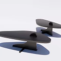 Two Modern Black Coffee Tables With Unique Curved Tops And Small Decor Items On Surface