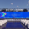 Marathon Event Venue With Blue Backdrop Stage And White Seats