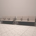 Gray Public Chairs With Metal Armrests Against Wall On Marble Floor
