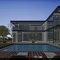 Modern Detached Villa Featuring Large Glass Windows Swimming Pool Outdoor Lounge and Blue Sky View