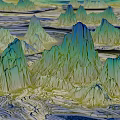 Dreamy Fantasy Landscape Featuring Jagged Mountain Peaks in Blue Green Tones and Winding Rivers