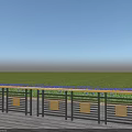 Decorative Fence Railings With Golden Panels On Wooden Deck By Green Grass And Blue Flowers