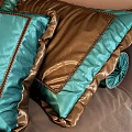 Double Bed With Brown Green Velvet Quilt Decorative Pillows And Upholstered Headboard