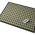 Square Rug With Black Border And Light Colored Dot Pattern Featuring Silver Tool On Top