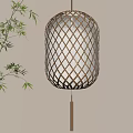 Glowing Decorative Lamp with Diamond Pattern Bamboo Shade and Bamboo Leaves on Light Colored Wall
