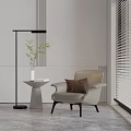 Modern Lounge Chair with Brown Pillow Small Side Table Vase Green Plants Floor Lamp