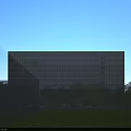 Modern Office Building Exterior With Glass Curtain Wall And Lush Tree Surroundings