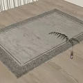 Beige Square Rug With Ornate Border On Wooden Floor And Small Potted Plant