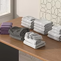 Folded Colorful Towels In Purple Grey White Tones Arranged On Wooden Table