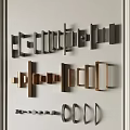 Modern Door Handles In Various Metal Designs Displayed On White Wall