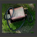 Vintage Red Gas Pump With Grass And Moss At The Base