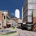 Vibrant Commercial Street With Modern Brick Buildings McDonald's Outdoor Seating Sunshades And Trees