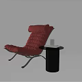 Modern Red Leather Lounge Chair With Black Side Table And Books