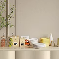 Ceramic Ware Display With White Plates Yellow Bowls On Light Wooden Countertop