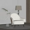 Plush Beige Accent Chair On Round Rug With Clear Acrylic Side Table And Floor Lamp