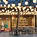 Outdoor Sanya Bar With Hanging String Lights Palm Trees Surfboards Bar Counter Tables Chairs