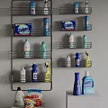 Neatly Arranged Colorful Laundry Supplies And Detergent Bottles On Metal Wall Shelves