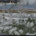 Snowy Garden Landscape With Bare Trees And Snow Covered Hills Under Cloudy Sky
