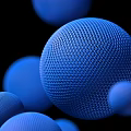 Commercial Equipment Components with Blue Mesh Textured Spheres in Various Sizes on Black Background