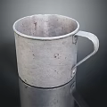 Silver Metal Cup With Handle Showing Scratches And Rust Spots On Reflective Dark Surface