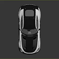 Sleek Silver And Black Sports Car With Large Rear Spoiler And Aggressive Front Design
