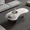 Modern Living Room Featuring Curved Coffee Table White Tabletop Tray Decorative Items And Gray Sofa