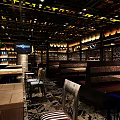 Stylish Restaurant Interior With Hanging Chandeliers Dining Tables Wine Racks And Green Plants