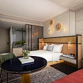 Hotel Guest Room With White Bed Linens Three Circular Wall Decor And Wooden Headboard