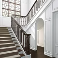 Elegant Staircase With Dark Metal Railing Geometric Design White Wainscoting Walls And Arched Doorway