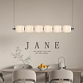 Modern Circular Chandelier Above Dining Table With Fruit Bowl Vase And Jane Wall Art