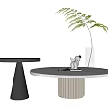 Modern Round Coffee Table With White Top Striped Base Decorative Plant Figurine And Book